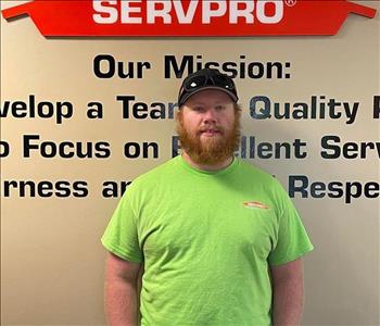 Employee in front of mission statement